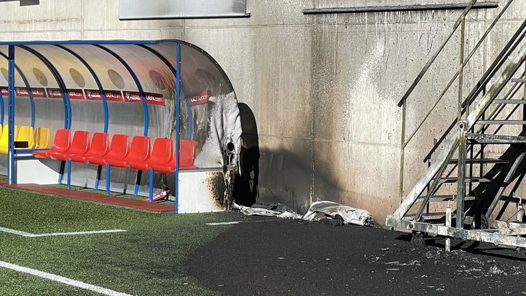 The dugout and a section of pitch are damaged after a fire at the Andorra National Stadium