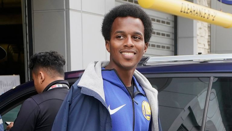 Golden State Warriors parking garage attendant Jonathan Amey, Jr. smiles as he looks for cars to enter the Chase Center before Saturday night's NBA clash between between the Warriors and the Oklahoma City Thunder