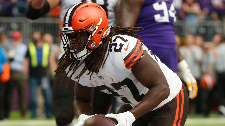 Cleveland Browns running back Kareem Hunt (27) scores on a 1-yard touchdown run ahead of Minnesota Vikings free safety Xavier Woods (23) during the first half of an NFL football game, Sunday, Oct. 3, 2021, in Minneapolis. (AP Photo/Bruce Kluckhohn)


