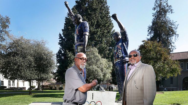 Carlos (left) and Smith in front of a statue that honours their iconic protest at San Jose State University in 2018