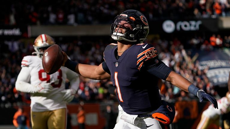 Chicago Bears quarterback Justin Fields begins to celebrate his touchdown against the San Francisco 49ers 