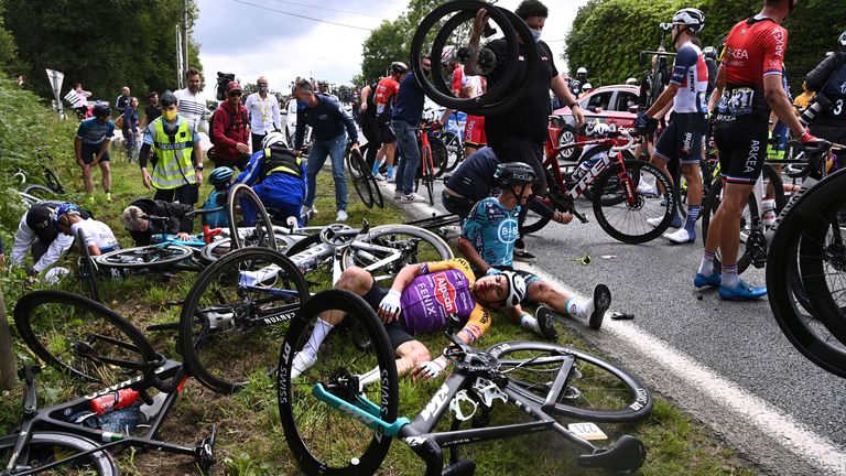 Italy's Kristian Sbaragli, left, and France's Bryan Coquard, right, lie on the ground after crashing during the first stage of the Tour de France cycling race over 197.8 kilometers (122.9 miles) with start in Brest and finish in Landerneau, France, Saturday, June 26, 2021. (Anne-Christine Poujoulat, Pool Photo via AP)