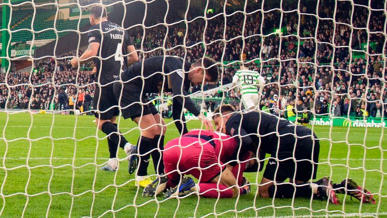 Livingston's Max Stryjek is congratulated by his team-mates after saving Giakoumakis' penalty