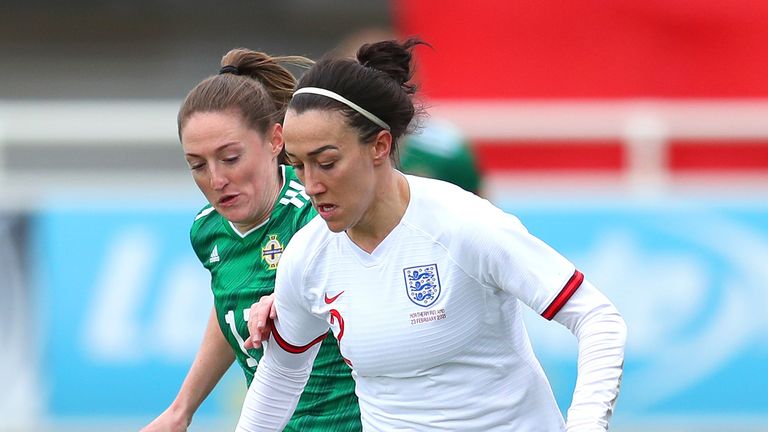 Lucy Bronze of England runs with the ball under pressure from Rebecca Holloway of Northern Ireland