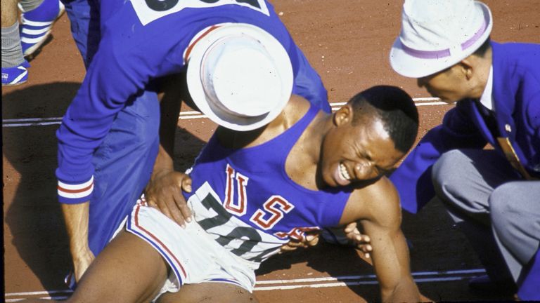 Pender grimaces in pain at the end of 100m semi-final heat during the 1964 Olympics