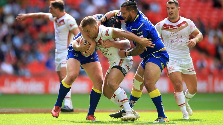Catalans Dragons v Warrington Wolves - Ladbrokes Challenge Cup - Final - Wembley Stadium
Cataland Dragons' Mickael Goudemand (centre) is tackled by Warrington Wolves' Ben Murdoch-Masila during the Ladbrokes Challenge Cup Final at Wembley Stadium, London.