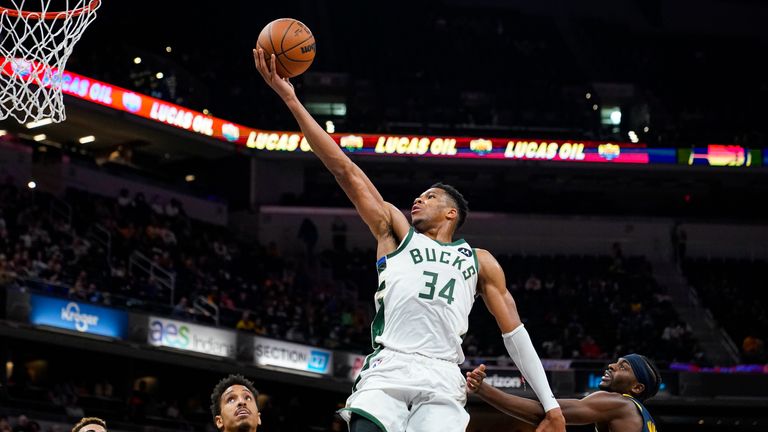 Milwaukee Bucks forward Giannis Antetokounmpo (34) shoots over Indiana Pacers guard Malcolm Brogdon (7) during the second half of an NBA basketball game in Indianapolis, Monday, Oct. 25, 2021. The Bucks defeated the Pacers 119-109.