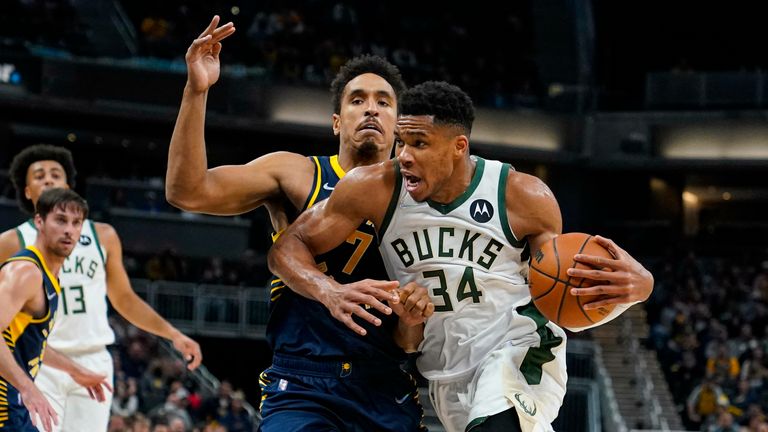 Milwaukee Bucks forward Giannis Antetokounmpo (34) drives past Indiana Pacers guard Malcolm Brogdon (7) during the second half of an NBA basketball game in Indianapolis, Monday, Oct. 25, 2021. The Bucks defeated the Pacers 119-109. 