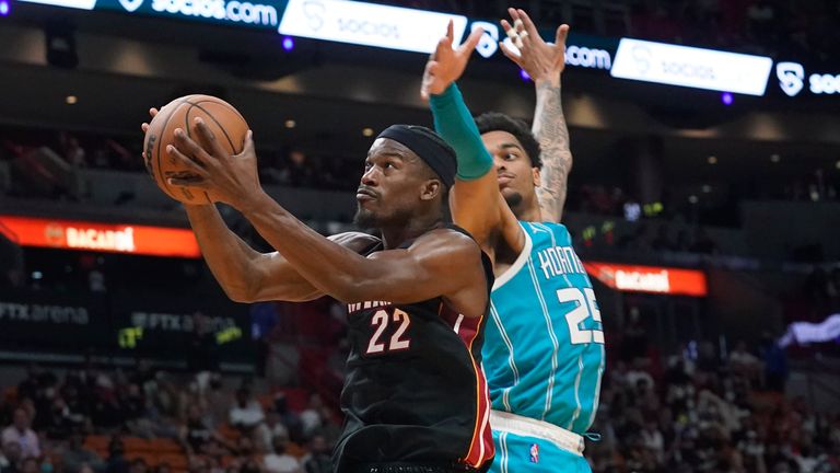 Miami Heat forward Jimmy Butler (22) drives to the basket as Charlotte Hornets forward P.J. Washington (25) defends during the second half of an NBA basketball game, Friday, Oct. 29, 2021, in Miami. (AP Photo/Marta Lavandier)


