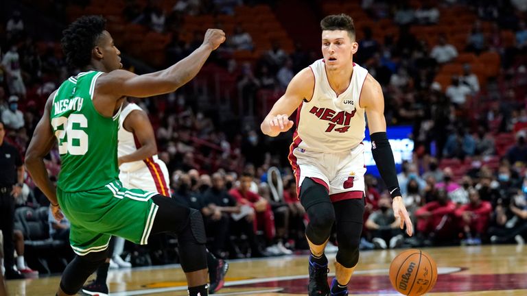 Miami Heat guard Tyler Herro (14) drives to the basket as Boston Celtics forward Aaron Nesmith (26) defends during the first half of a preseason NBA basketball game, Friday, Oct. 15, 2021, in Miami. (AP Photo/Lynne Sladky)


