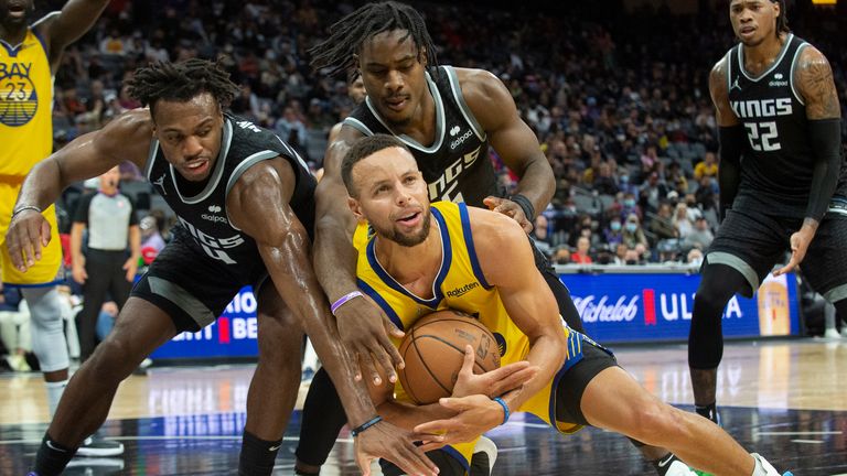 Buddy Hield and Davion Mitchell pressure Steph Curry during the game between the Sacramento Kings and Golden State Warriors