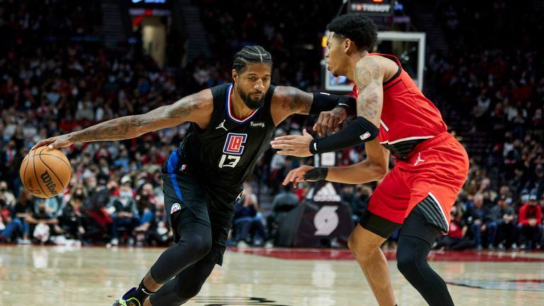 Los Angeles Clippers guard Paul George, left, dribbles the ball around Portland Trail Blazers guard Anfernee Simons during the second half of an NBA basketball game in Portland, Ore., Friday, Oct. 29, 2021. (AP Photo/Craig Mitchelldyer)


