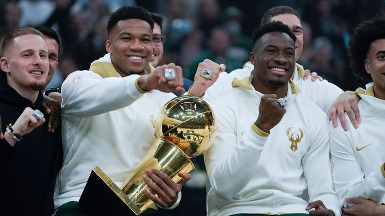 Milwaukee Bucks' Giannis Antetokounmpo and Thanasis Antetokounmpo show off their championship rings before an NBA basketball game between the Milwaukee Bucks and the Brooklyn Nets, Tuesday, Oct. 19, 2021, in Milwaukee. (AP Photo/Morry Gash)