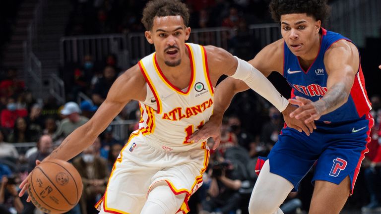 CORRECTS TO MONDAY, OCT 25, 2021 - Atlanta Hawks guard Trae Young (11) dribbles past Detroit Pistons guard Killian Hayes, right, during the first half of an NBA basketball game Monday, Oct. 25, 2021, in Atlanta.