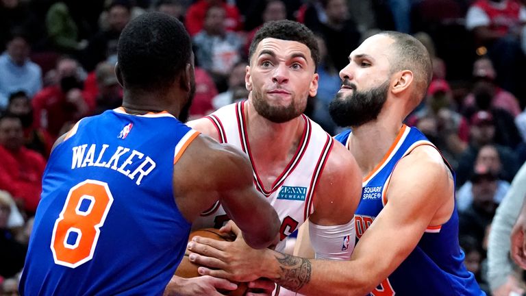 Chicago Bulls guard Zach LaVine, center, battles for the ball against New York Knicks guards Kemba Walker, left, and Evan Fournier during the second half of an NBA basketball game Thursday, Oct. 28, 2021, in Chicago.