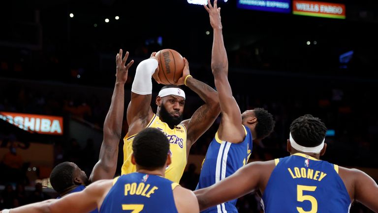 Los Angeles Lakers forward LeBron James, top left, looks to pass the ball against the Golden State Warriors during the first half of an NBA basketball game in Los Angeles, Tuesday, Oct. 19, 2021. (AP Photo/Ringo H.W. Chiu)


