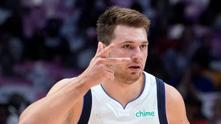 Dallas Mavericks guard Luka Doncic (77) celebrates a three-point basket as he makes his way past Los Angeles Clippers Harry Giles III