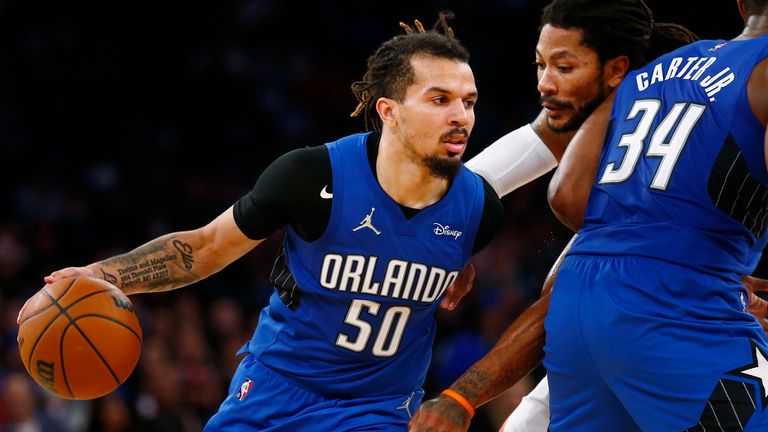 Orlando Magic&#39;s Cole Anthony (50) dribbles around teammate Wendell Carter Jr. (34) as New York Knicks&#39; Derrick Rose (4) defends during an NBA basketball game Sunday, Oct. 24, 2021, in New York.