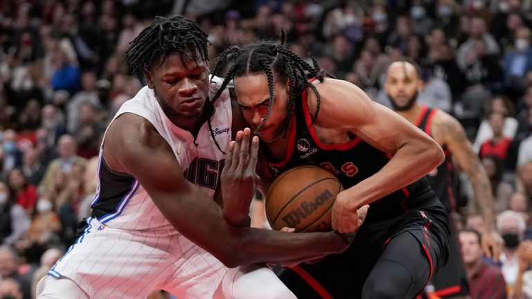 Toronto Raptors guard Dalano Banton (45) and Orlando Magic centre Mo Bamba (5) vie for the ball during the second half of an NBA basketball game Friday, Oct. 29, 2021, in Toronto. (Nathan Denette/The Canadian Press via AP)


