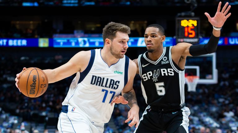 Dallas Mavericks guard Luka Doncic (77) is defended by San Antonio Spurs guard Dejounte Murray (5) during the first half of an NBA basketball game Thursday, Oct. 28, 2021, in Dallas.