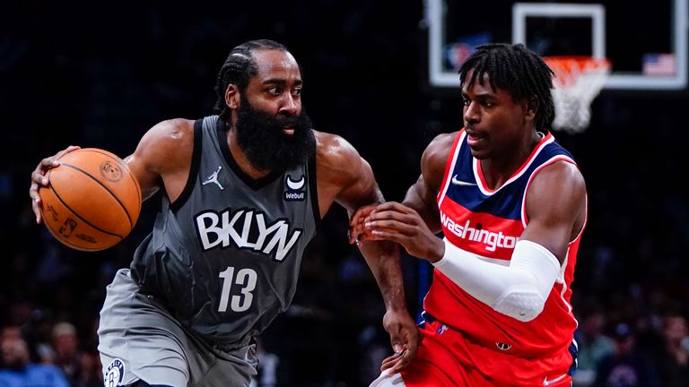 Brooklyn Nets&#39; James Harden (13) drives past Washington Wizards&#39; Aaron Holiday (4) during the second half of an NBA basketball game Monday, Oct. 25, 2021, in New York. The Nets won 104-90.