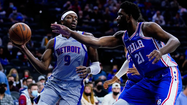 Detroit Pistons' Jerami Grant (9) tries to get past Philadelphia 76ers' Joel Embiid (21) during the first half of an NBA basketball game, Thursday, Oct. 28, 2021, in Philadelphia.