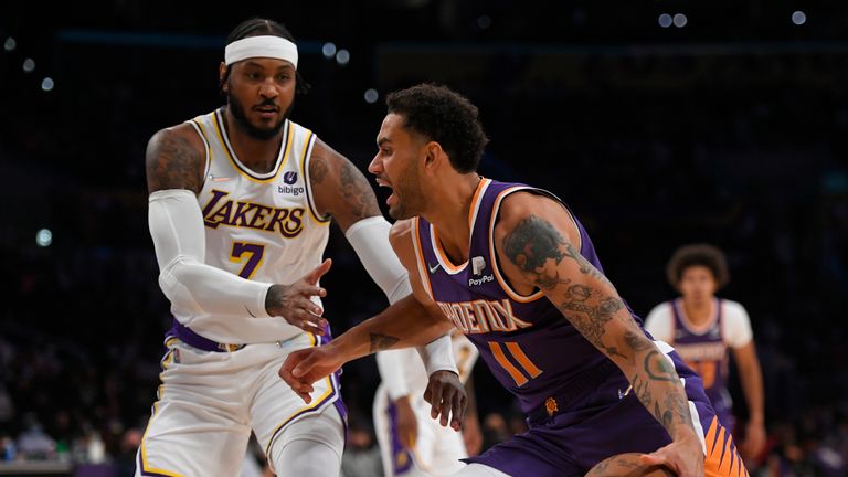 Los Angeles Lakers forward Carmelo Anthony (7) guards Phoenix Suns forward Abdel Nader (11) in the first half of a preseason NBA basketball game in Los Angeles, Sunday, Oct. 10, 2021. (AP Photo/John McCoy)



