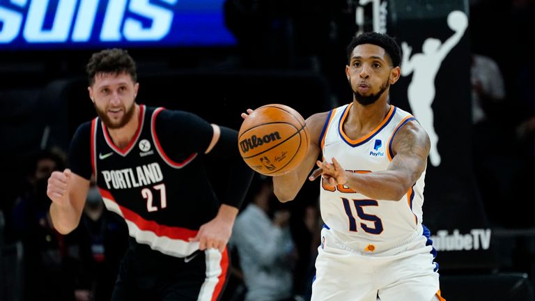 Phoenix Suns guard Cameron Payne (15) passes as Portland Trail Blazers center Jusuf Nurkic (27) pursues during the second half of a preseason NBA basketball game, Wednesday, Oct. 13, 2021, in Phoenix. (AP Photo/Matt York)


