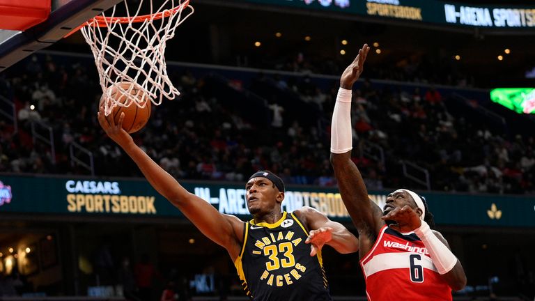 Indiana Pacers center Myles Turner (33) goes to the basket past Washington Wizards center Montrezl Harrell (6) during the second half of an NBA basketball game, Friday, Oct. 22, 2021, in Washington. (AP Photo/Nick Wass)



