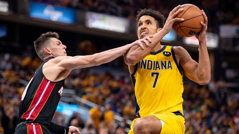 Indiana's Malcolm Brogdon drives to the basket as Miami's Tyler Herro attempts to foul