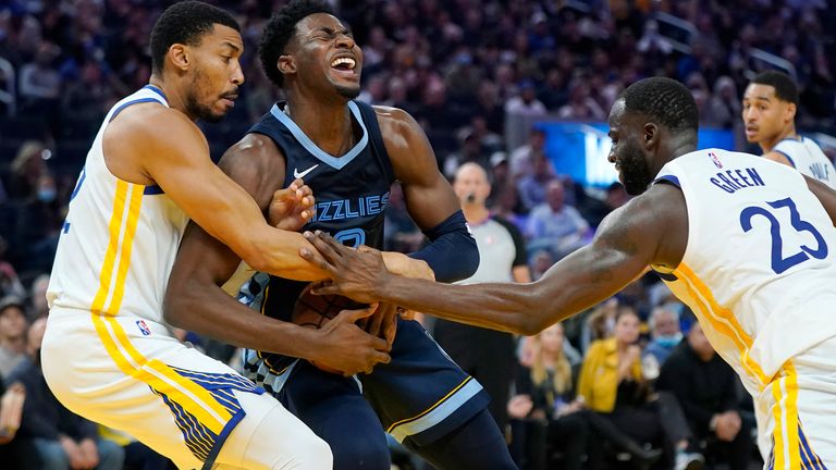 Memphis Grizzlies forward Jaren Jackson Jr., middle, is defended by Golden State Warriors forward Otto Porter Jr., left, and forward Draymond Green (23) during the second half of an NBA basketball game in San Francisco, Thursday, Oct. 28, 2021.