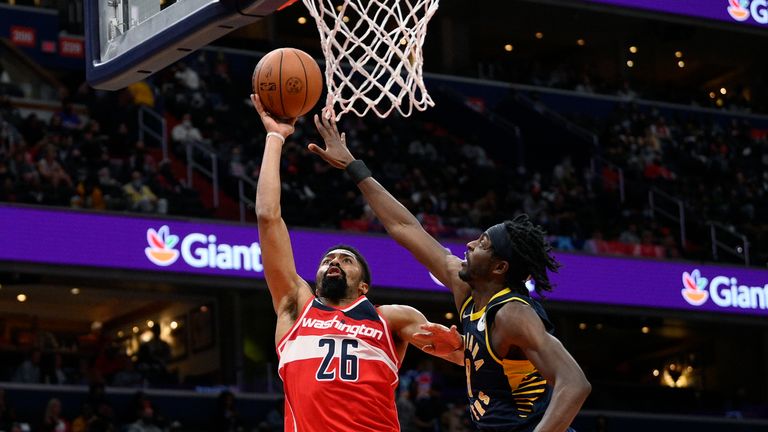 Washington Wizards guard Spencer Dinwiddie (26) goes to the basket against Indiana Pacers forward Justin Holiday, right, during the first half of an NBA basketball game Friday, Oct. 22, 2021, in Washington. (AP Photo/Nick Wass)


