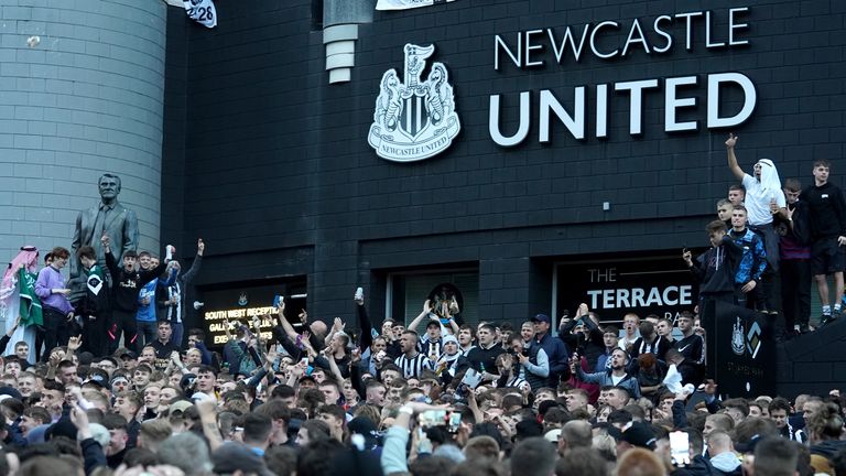 Newcastle United fans celebrate at St James' Park following the announcement that The Saudi-led takeover of Newcastle has been approved