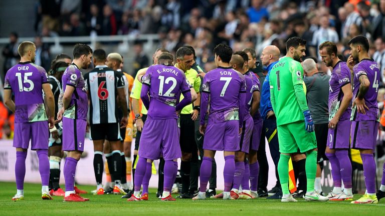 PA - Newcastle and Tottenham players wait for the match to be restarted