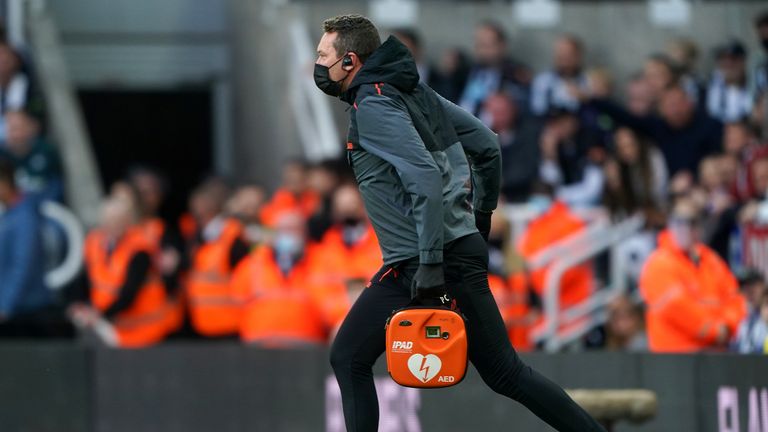 PA - A member of the Newcastle medical team brings a defibrillator to the fan 