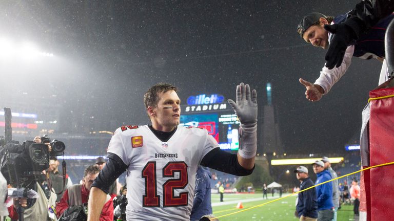 Tampa Bay Buccaneers quarterback Tom Brady (12) greets a fan after defeating the New England Patriots in an NFL football game, Sunday, Oct. 3, 2021, in Foxborough, Mass. (AP Photo/Greg M. Cooper)


