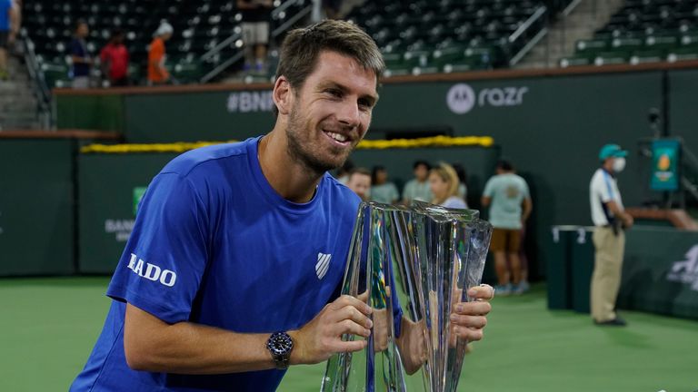 Cameron Norrie, of Britain, puts his lips to his trophy after defeating Nikoloz Basilashvili, of Georgia, in the singles final at the BNP Paribas Open tennis tournament Sunday, Oct. 17, 2021, in Indian Wells, Calif. (AP Photo/Mark J. Terrill)


