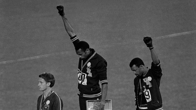 In this Oct. 16, 1968 file photo, United States athletes Tommie Smith, top center, and John Carlos, top right, extend their gloved fists skyward during the playing of the "Star-Spangled Banner" after Smith received the gold and Carlos the bronze for the 200-meter run at the Summer Olympic Games in Mexico City. Australia's silver medalist Peter Norman is at left. When Tommie Smith bowed his head and thrust a black-gloved fist toward the sky from the top of the Olympic podium 45 years ago, he was 