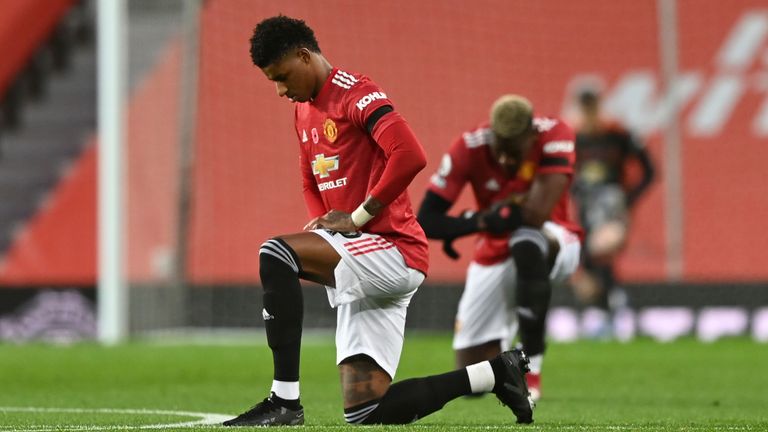 Manchester United's Marcus Rashford takes a knee in support of Black Lives Matter movement prior the English Premier League soccer match between Manchester United and Arsenal at the Old Trafford stadium in Manchester, England, Sunday, Nov. 1, 2020