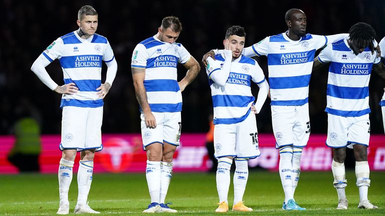 QPR players stand dejected as the penalty shootout ebbs away