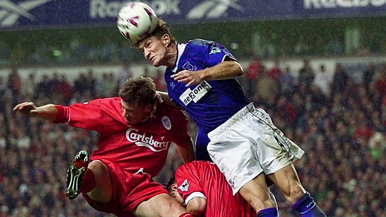 This picture can only be used within the context of an editorial feature. Everton defender Richard Gough (R) leaps high to win a header against Liverpool striker Erik Meijer, during their FA Premiership derby football match at Anfield. 