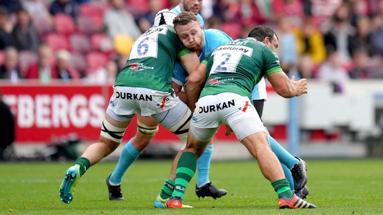 Gloucester's Ruan Ackermann (centre) is tackled by London Irish's Matt Rogerson (left) and Agustin Creevy during the Gallagher Premiership match at the Brentford Community Stadium, London. Picture date: Sunday October 17, 2021.