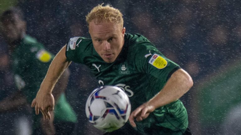 Plymouth&#39;s Ryan Broom stoops to head the ball at a waterlogged Home Park