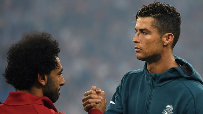Madrid&#39;s Cristiano Ronaldo (R) and Liverpool&#39;s Mohamed Salah lock hands before the match