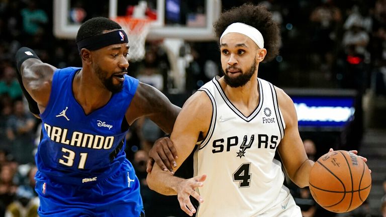 San Antonio Spurs&#39; Derrick White (4) drives against Orlando Magic&#39;s Terrance Ross during the second half of an NBA basketball game on Wednesday, Oct. 20, 2021, in San Antonio, Texas. San Antonio won 123-97. (AP Photo/Darren Abate)