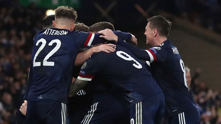 Scotland players mob Scott McTominay after he scored an injury-time winner