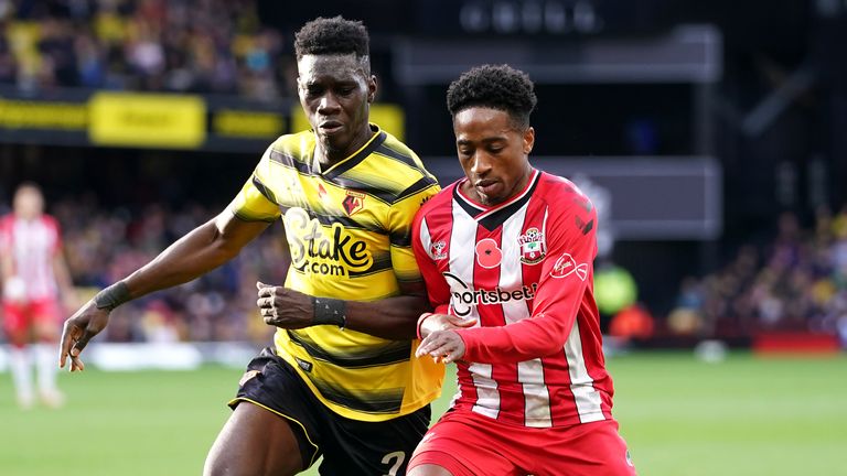 Ismaila Sarr and Kyle Walker-Peters compete for the ball