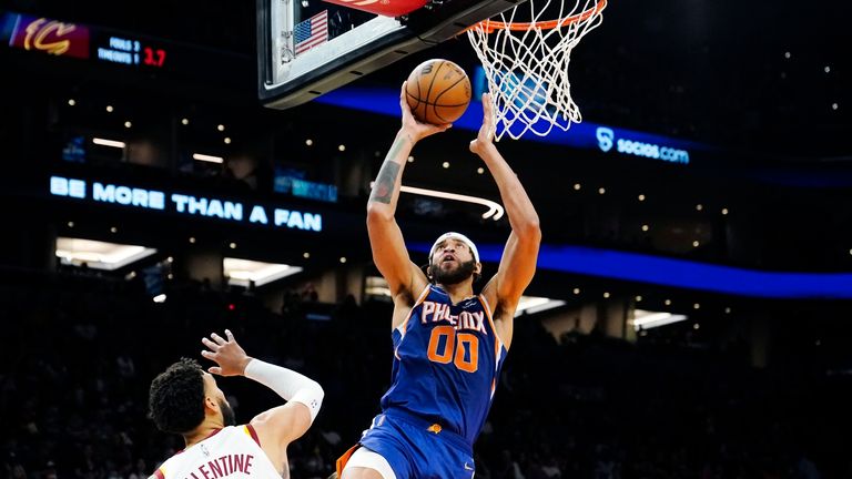 Phoenix Suns center JaVale McGee (00) scores against Cleveland Cavaliers guard Denzel Valentine (45) during the second half of an NBA basketball game Saturday, Oct. 30, 2021, in Phoenix. The Suns won 101-92. (AP Photo/Ross D. Franklin)


