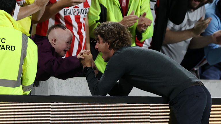 Thomas Frank celebrates Brentford's win over Arsenal with fan Woody O'Rourke