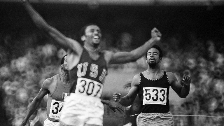 Tommie Smith of the U.S. celebrates as he crosses the finish line, winning the 200-meter sprint in the Olympic games in Mexico City, Oct 16, 1968. Smith set a new world record with a time of 19.8.